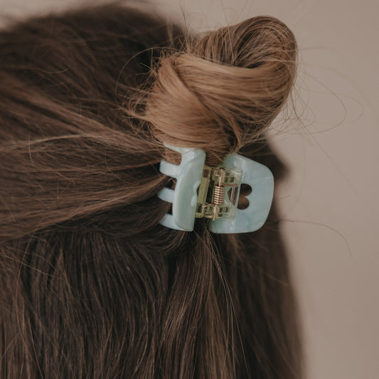 Kleine Haarspange in Mint mit Herzdetail im halboffenen braunen Haar