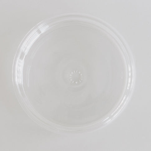 Transparente Bubbles Schale von oben fotografiert – modernes Glas-Design mit Logo im Schalenboden.