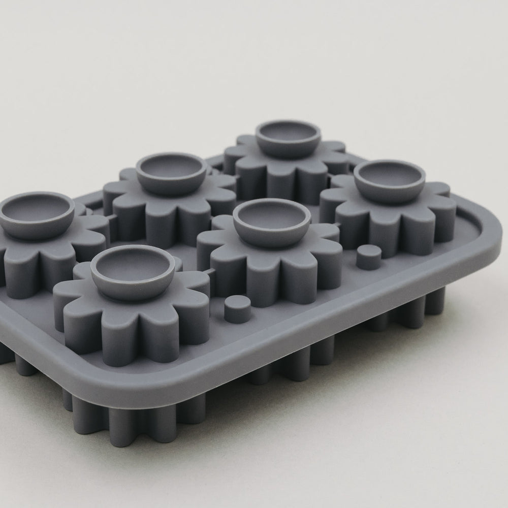 Rückseite der grauen Blüten-Eiswürfelform mit runden Öffnungen.