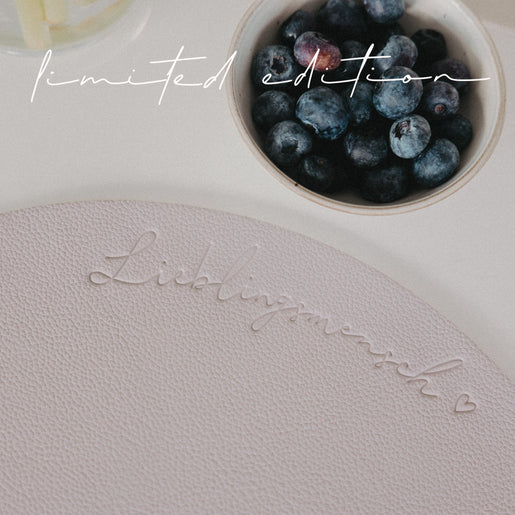 Nahaufnahme des Schriftzugs „Lieblingsmensch“ auf fliederfarbenem wendbarem Platzset.