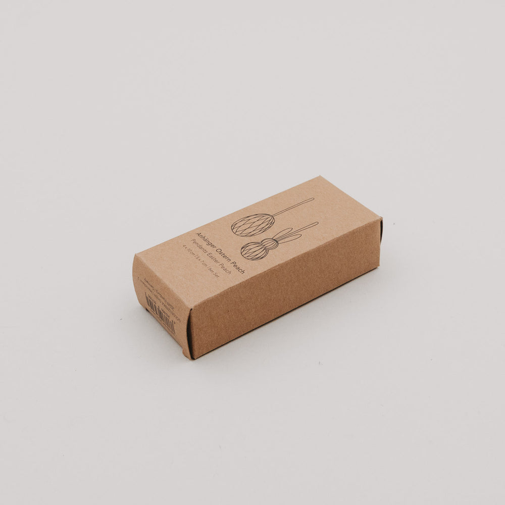 Kraftpapierbox des peachfarbenen Papieranhänger-Sets mit minimalistischer Illustration.
