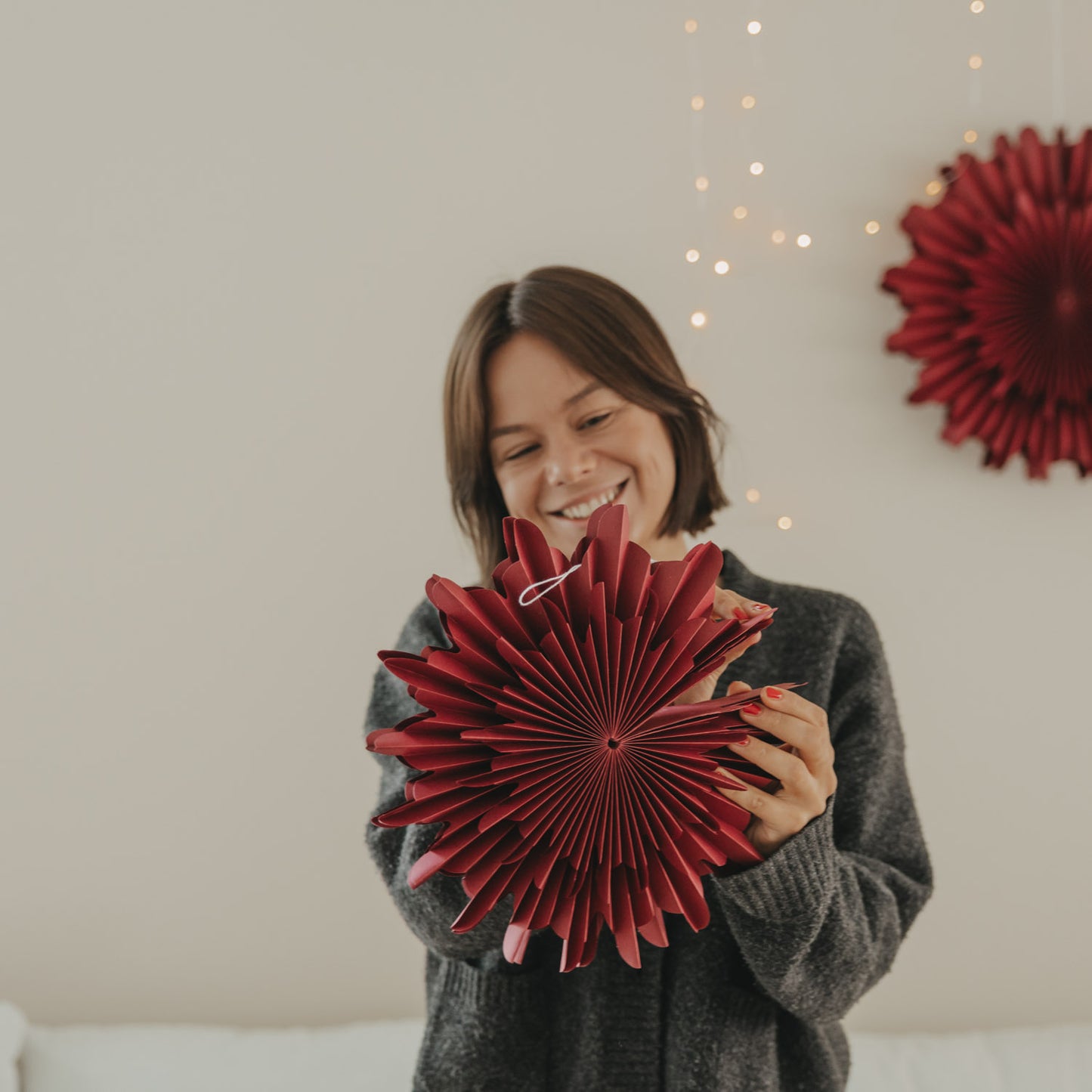 Rote Papierschneeflocke 30 cm wird als festliche Weihnachtsdekoration aufgefaltet
