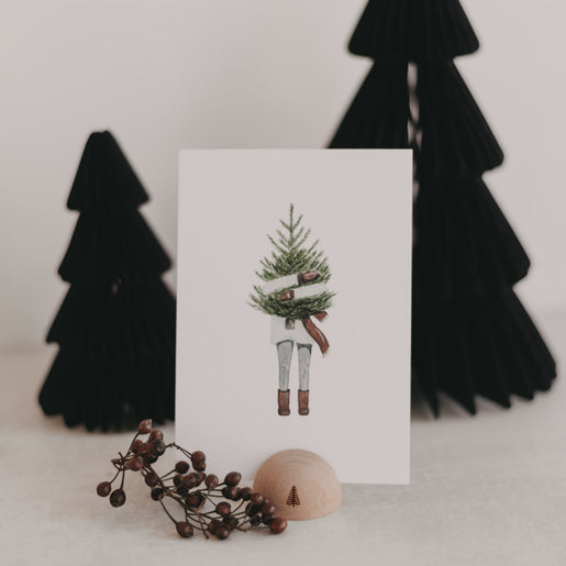 Kartenständer Halbrund Tanne mit Postkarte und Deko vor schwarzen Papierbäumen