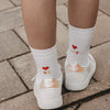 Kinder Socken weiß mit Herz und „Be Happy“ Schriftzug, getragen mit Sneakern im Alltag