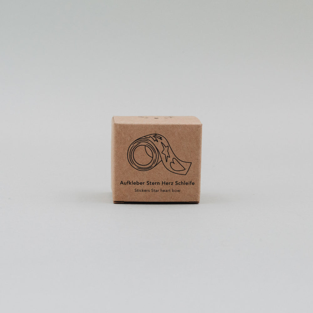 Kartonverpackung der goldenen Aufkleberrolle mit Motivdarstellung Stern, Herz, Schleife